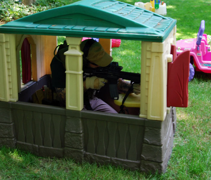 Merrill taking cover in a Little Tikes play house.