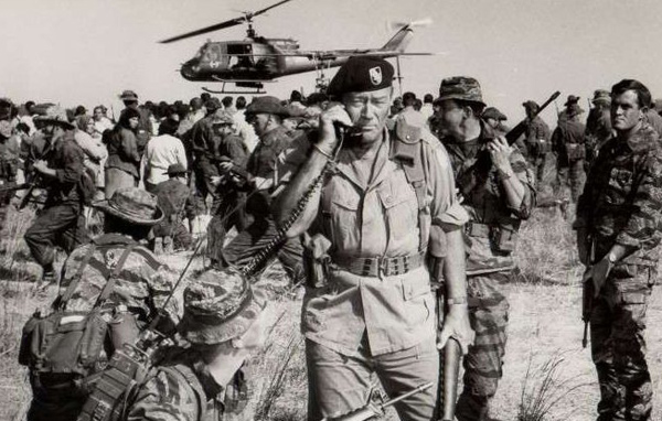 Black and white photo with John Wayne in the foreground.