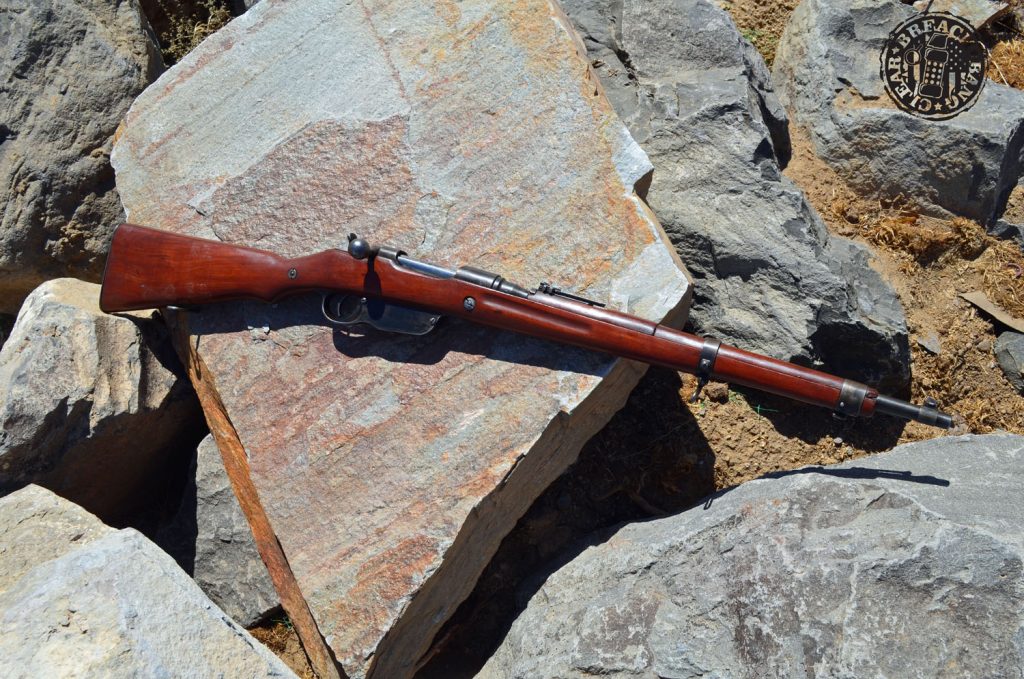 The Mannlicher M1895 (Steyr M95) bolt gun had significant recoil. A Steyr M95 rifle displayed on a grey rock background.