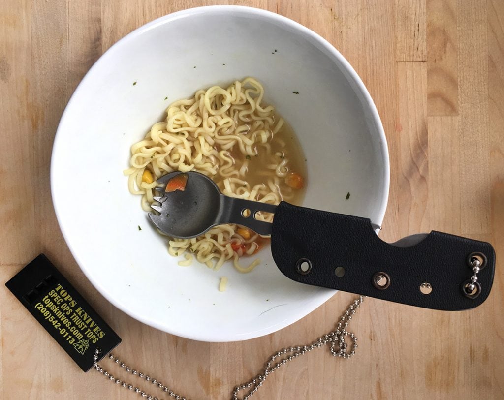 Using a tactical spork on a kid's bowl of ramen noodles.