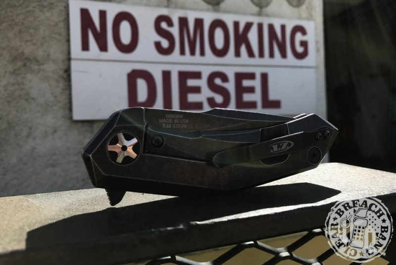 Sign in background reads: No smoking. Diesel. Close up of the folding knife.