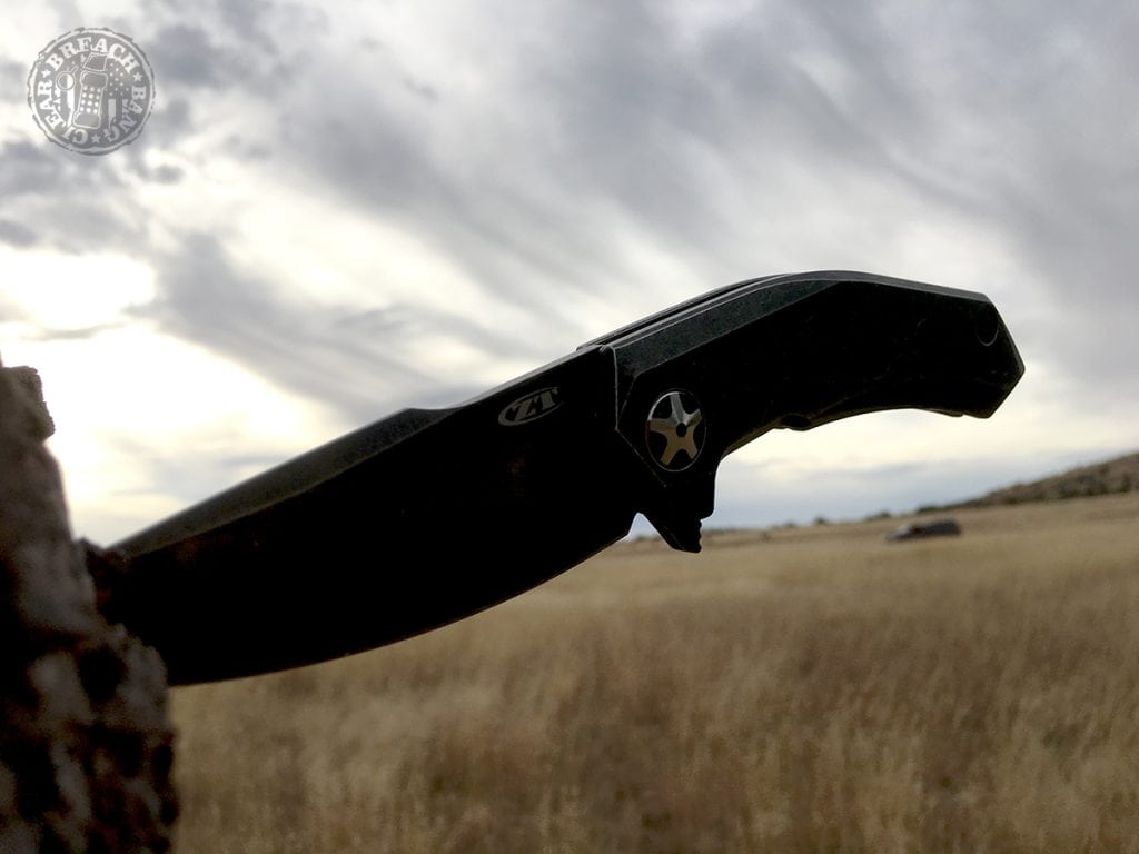 Zero Tolerance ZT0095BW folding knife stuck in a tree stump.