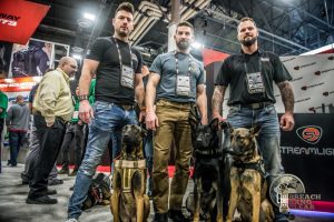 Baden K9 service dogs with their trainers at 2019 SHOT Show.