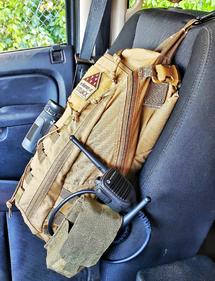 Use a carabiner to hang your bag from the passenger seat headrest whien doing surveillance from a vehicle.