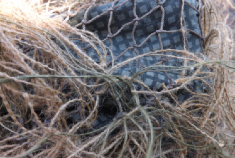 burlap string attached to netting on ghillie suit