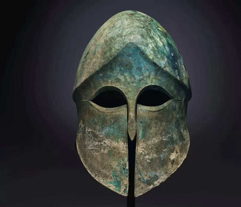 An ancient bronze Corinthian helmet.
