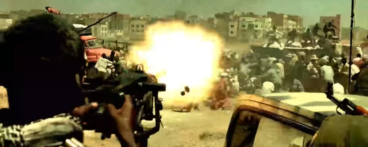 A gunner in the back of a Somali technical opens fire on a crowd, Blackhawk Down opening sequence. 