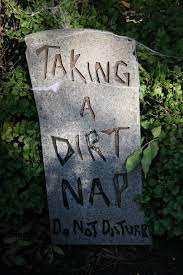 A stone slab that says "TAKING A DIRT NAP. DO NOT DISTURB.".