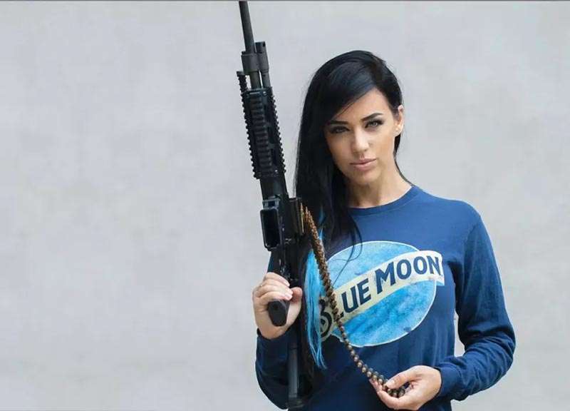 Woman holding a Fightlite Industries belt fed rifle