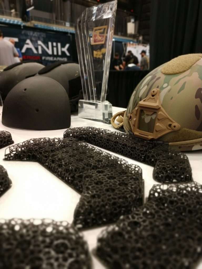 Golden Trigger Award surrounded by Hard Head Veteran gear, Micro Lattice in focus.