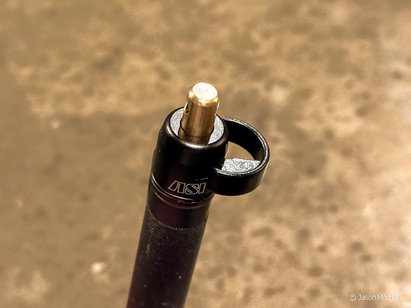 The safety on the ASP Defender flips out allowing you to push down on the brass button. [Photo: Jason Mosher]