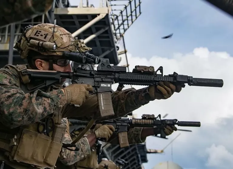 Two soldiers firing a rifle.