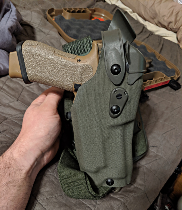G19X holstered in Green Safariland holster.