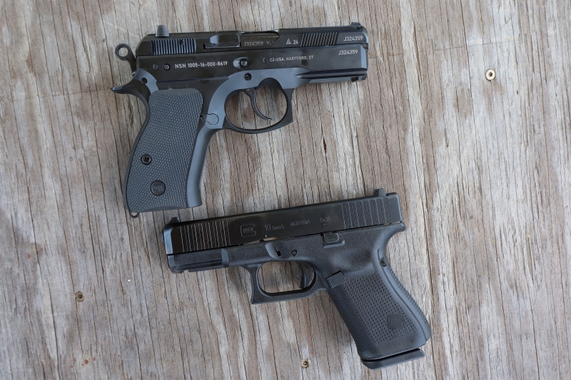 cz p01 and glock 19 pistols laid on a table