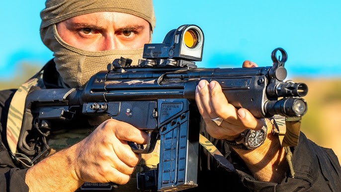 The host of the YouTube channel "Administrative Results" is shown holding a short-barreled G3 clone from one of his videos.