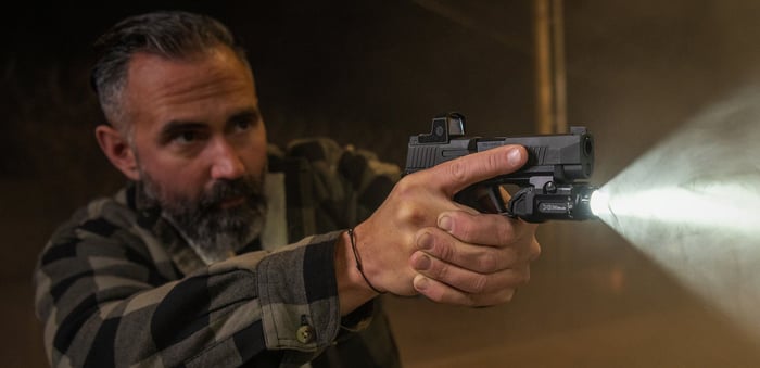 Looking for threats with a Surefire pistol light mounted to a CCW handgun.