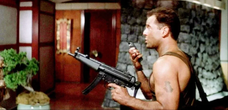 John McClane (Bruce Willis) carrying an MP5 in a scene from Die Hard.