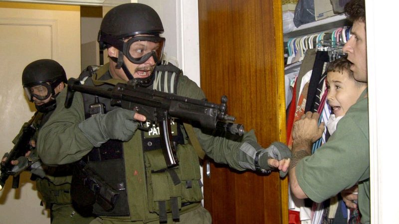 Famous photo of a Border Patrol officer coming for Elián González in 2000